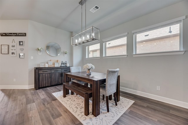 4105 Silver Spur Ct, Aubrey, TX 76227 - dining area with a chandelier, wood finished floors, and baseboards