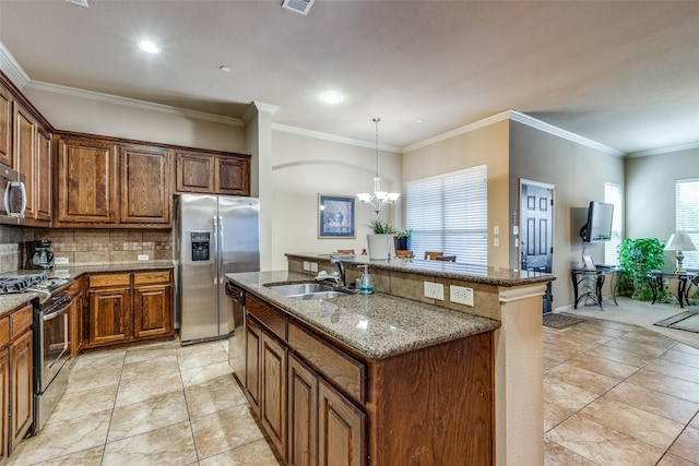 5321 Locust Dr, Mckinney, TX 75070 - kitchen featuring stainless steel appliances, a sink, a kitchen island with sink, tasteful backsplash, and healthy amount of natural light