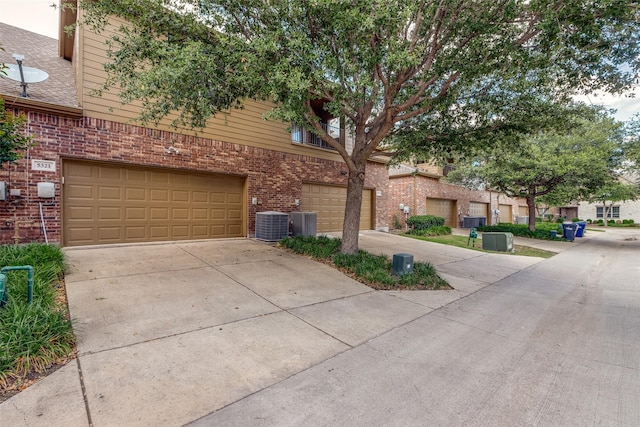 5321 Locust Dr, Mckinney, TX 75070 - view of front of property with brick siding, driveway, a garage, and central AC