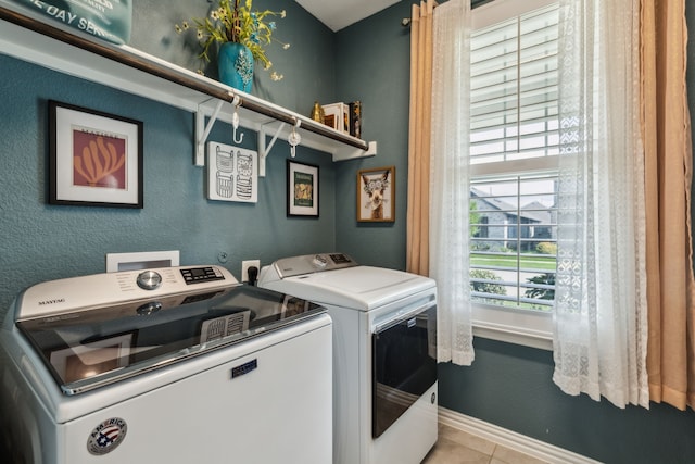 2516 Stella Ln, Northlake, TX 76247 - laundry room featuring washing machine and clothes dryer, tile patterned flooring, and baseboards
