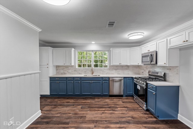 6130 Yarbrough Rd, Shreveport, LA 71119 - kitchen featuring blue cabinetry, stainless steel appliances, white cabinets, ornamental molding, and a wainscoted wall