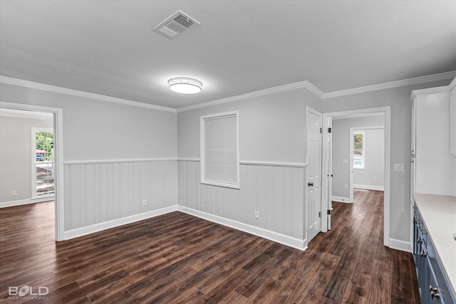 6130 Yarbrough Rd, Shreveport, LA 71119 - empty room with dark wood finished floors, healthy amount of natural light, crown molding, baseboards, and a wainscoted wall