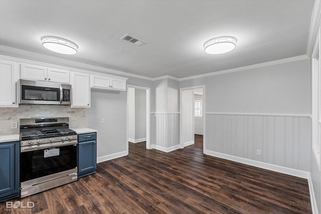 6130 Yarbrough Rd, Shreveport, LA 71119 - kitchen featuring stainless steel appliances, blue cabinets, light countertops, white cabinetry, and ornamental molding