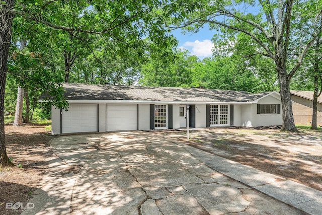 6130 Yarbrough Rd, Shreveport, LA 71119 - ranch-style house featuring concrete driveway, a garage, and french doors