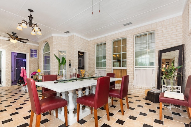 624 Horseshoe Bnd, Royse City, TX 75189 - dining area with brick wall, ceiling fan, and a chandelier