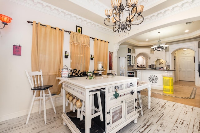 624 Horseshoe Bnd, Royse City, TX 75189 - dining area with arched walkways, a chandelier, crown molding, a tray ceiling, and light wood finished floors