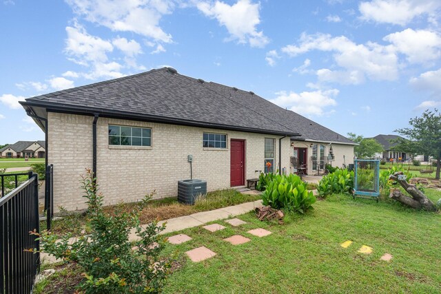 624 Horseshoe Bnd, Royse City, TX 75189 - rear view of house featuring a shingled roof, brick siding, cooling unit, and a patio area