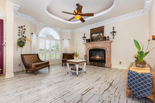 624 Horseshoe Bnd, Royse City, TX 75189 - living area with a glass covered fireplace, a ceiling fan, baseboards, a raised ceiling, and crown molding