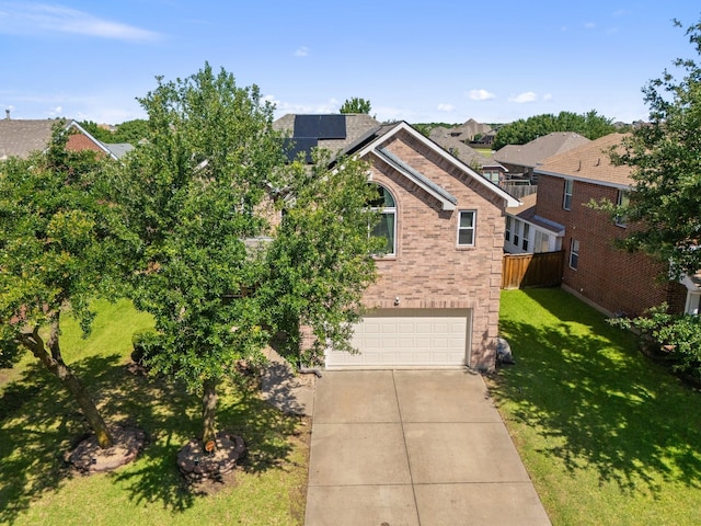 3148 Guadaloupe, Grand Prairie, TX 75054 - view of front of home featuring an attached garage, driveway, roof mounted solar panels, and brick siding