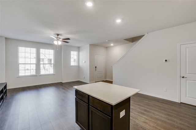 2112 Steer Creek Pl, Mesquite, TX 75149 - kitchen with ceiling fan, dark wood finished floors, light countertops, baseboards, and a kitchen island