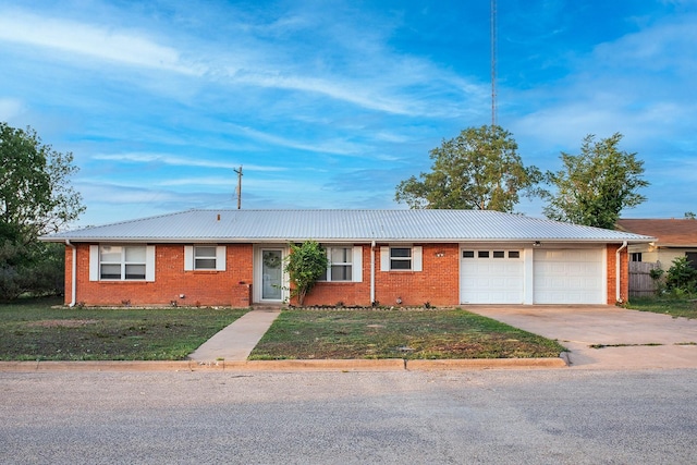 403 W China St, Brady, TX 76825 - ranch-style house featuring driveway, a garage, brick siding, a front yard, and metal roof