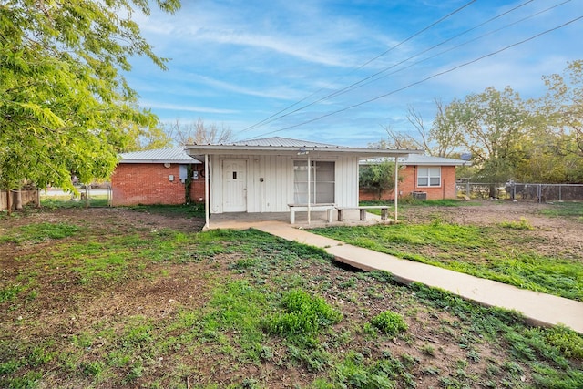 403 W China St, Brady, TX 76825 - rear view of house featuring board and batten siding and brick siding