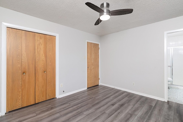 403 W China St, Brady, TX 76825 - unfurnished bedroom featuring wood finished floors, a closet, a textured ceiling, connected bathroom, and baseboards