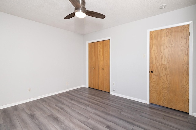 403 W China St, Brady, TX 76825 - spare room featuring dark wood finished floors, a ceiling fan, baseboards, and a textured ceiling
