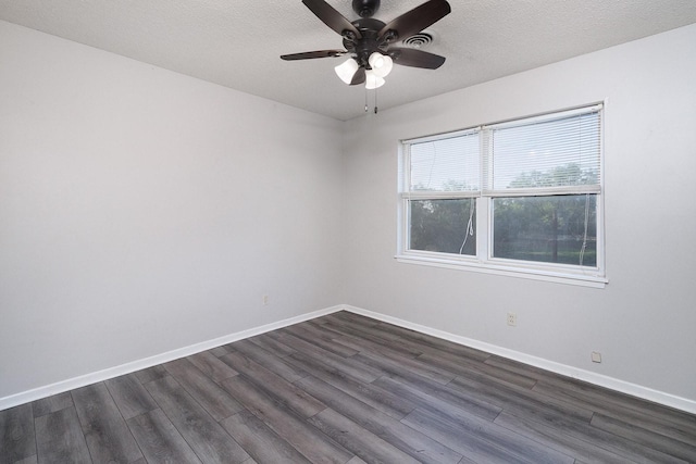 403 W China St, Brady, TX 76825 - spare room with dark wood-style floors, ceiling fan, baseboards, and a textured ceiling