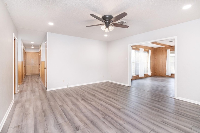 403 W China St, Brady, TX 76825 - unfurnished room featuring light wood finished floors, a ceiling fan, recessed lighting, baseboards, and a textured ceiling