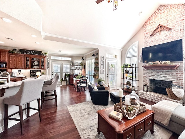 599 N Weldon, Frankston, TX 75763 - living area featuring a brick fireplace, crown molding, dark wood-type flooring, ceiling fan, and high vaulted ceiling