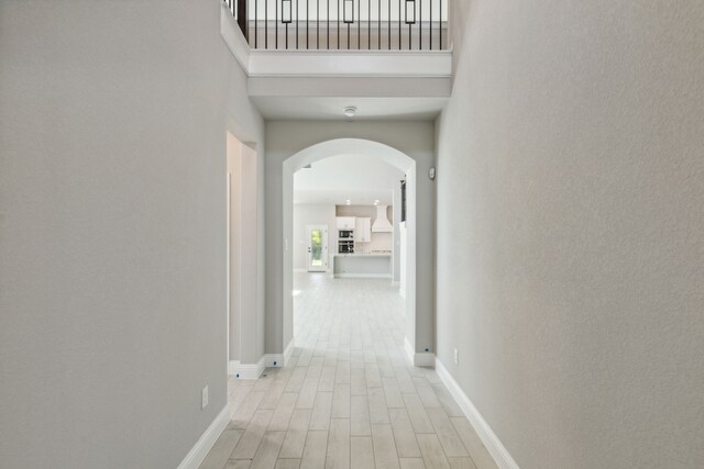 1105 Alaska, Forney, TX 75126 - hall featuring arched walkways, light wood-style floors, and baseboards