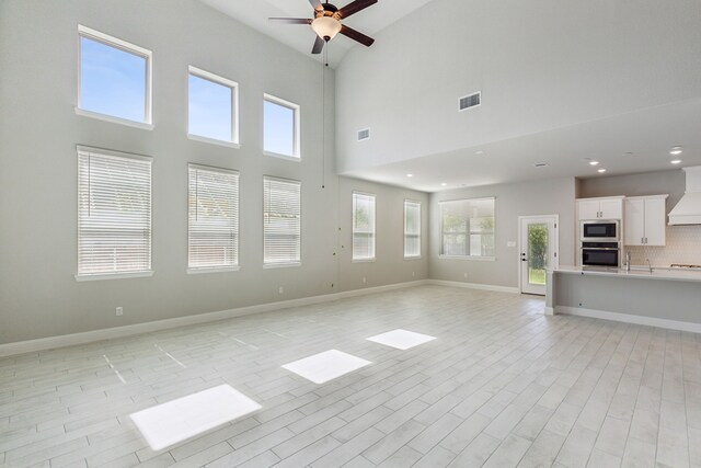 1105 Alaska, Forney, TX 75126 - unfurnished living room featuring ceiling fan, baseboards, light wood-style floors, a sink, and recessed lighting