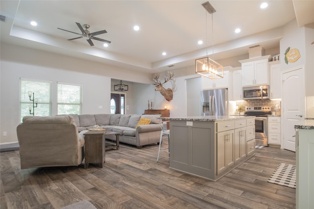 17294 Hidden Valley Ln, Flint, TX 75762 - kitchen featuring appliances with stainless steel finishes, open floor plan, backsplash, a center island, and ceiling fan