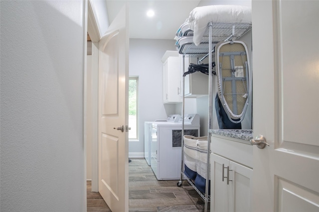 17294 Hidden Valley Ln, Flint, TX 75762 - laundry area with washing machine and clothes dryer, cabinet space, and wood finished floors