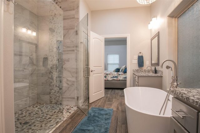 17294 Hidden Valley Ln, Flint, TX 75762 - full bathroom featuring vanity, a stall shower, a freestanding tub, ensuite bathroom, and wood finished floors