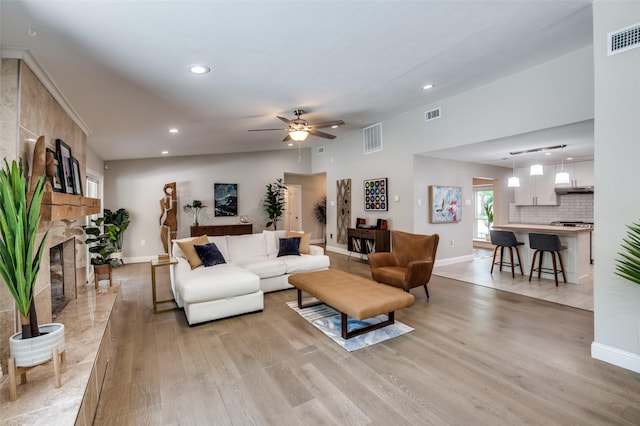 3385 Northaven Rd, Dallas, TX 75229 - living area featuring light wood finished floors, baseboards, recessed lighting, ceiling fan, and a stone fireplace