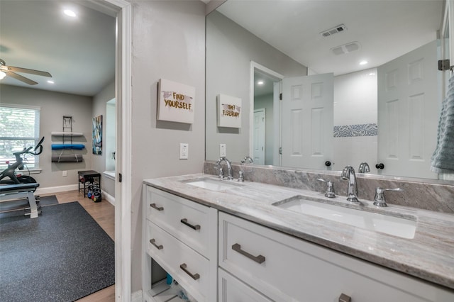 3385 Northaven Rd, Dallas, TX 75229 - bathroom featuring a ceiling fan, double vanity, wood finished floors, baseboards, and recessed lighting