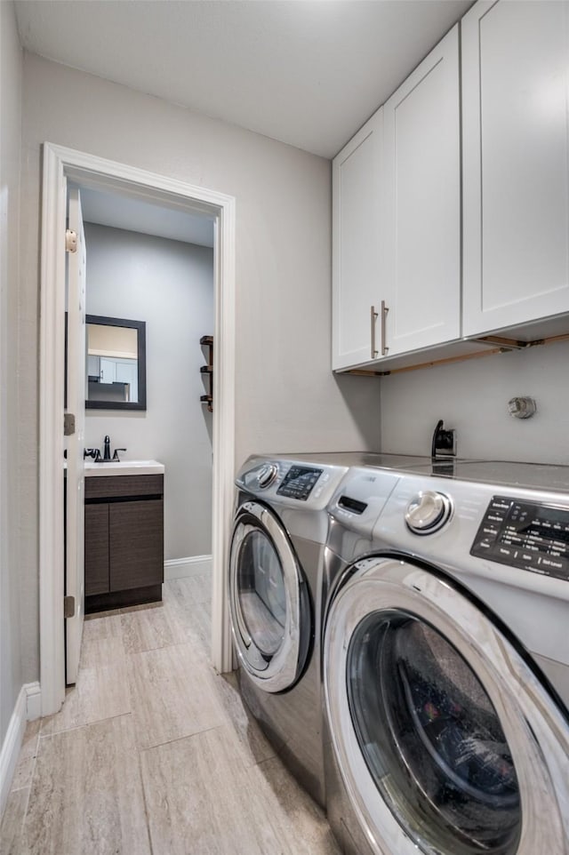 3385 Northaven Rd, Dallas, TX 75229 - washroom with cabinet space, separate washer and dryer, and baseboards