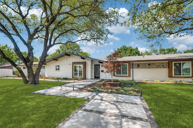 3385 Northaven Rd, Dallas, TX 75229 - view of front of home featuring brick siding, a front lawn, and board and batten siding