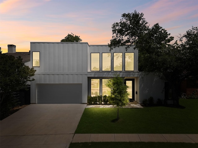 3941 Adrian Dr, Dallas, TX 75209 - modern home featuring a lawn, driveway, and an attached garage