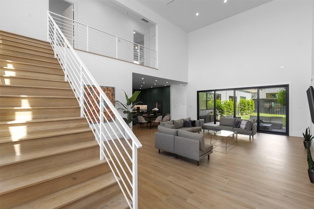 3941 Adrian Dr, Dallas, TX 75209 - living area featuring a high ceiling, stairway, and light wood finished floors