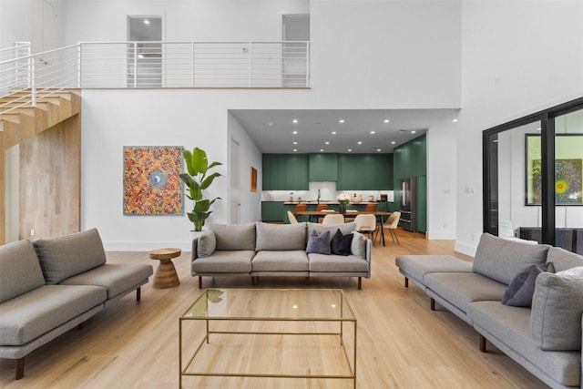 3941 Adrian Dr, Dallas, TX 75209 - living room featuring a towering ceiling, light wood-type flooring, and baseboards