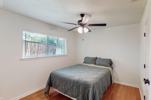 1803 Travis St, Garland, TX 75042 - bedroom featuring wood finished floors and a ceiling fan
