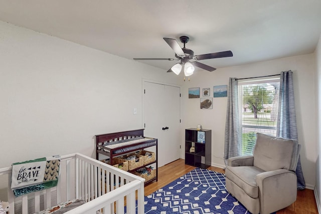 1803 Travis St, Garland, TX 75042 - bedroom featuring wood finished floors, a crib, and ceiling fan
