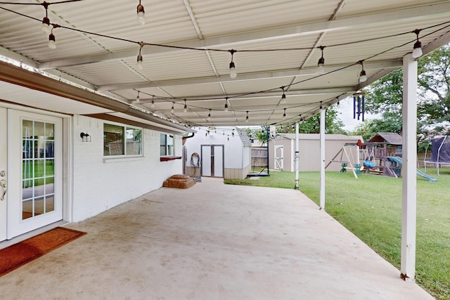 1803 Travis St, Garland, TX 75042 - view of patio / terrace featuring a shed and a playground