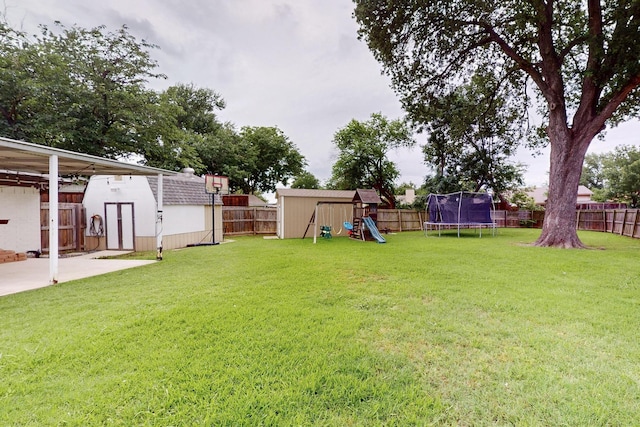1803 Travis St, Garland, TX 75042 - fenced backyard with a storage unit, a trampoline, a playground, and a patio area