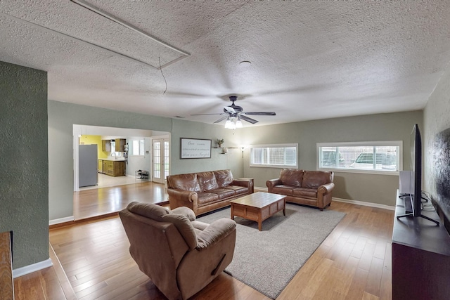 1803 Travis St, Garland, TX 75042 - living area featuring attic access, wood-type flooring, a ceiling fan, and a textured ceiling