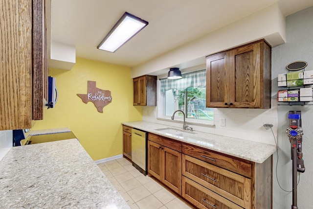 1803 Travis St, Garland, TX 75042 - kitchen featuring dishwashing machine, decorative backsplash, stainless steel microwave, light tile patterned floors, and brown cabinets