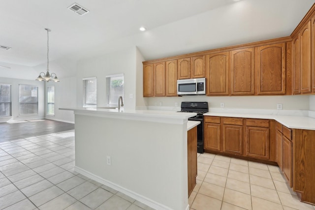 8208 Lonesome Spur Trl, Mckinney, TX 75070 - kitchen with stainless steel microwave, black gas range, light tile patterned floors, plenty of natural light, and recessed lighting