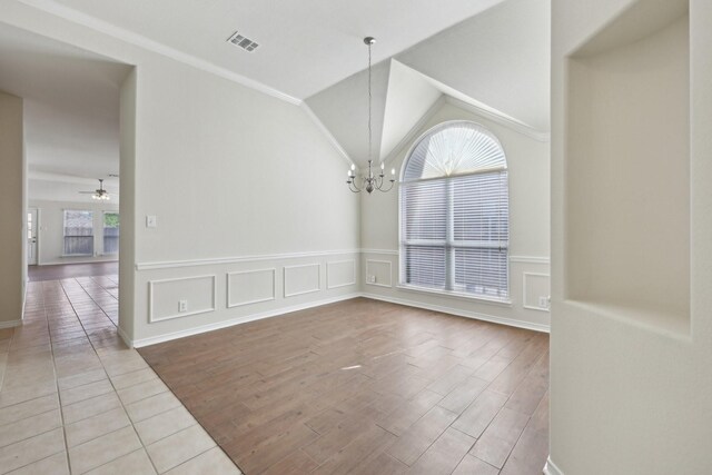 8208 Lonesome Spur Trl, Mckinney, TX 75070 - unfurnished room with a chandelier, wood finished floors, a ceiling fan, vaulted ceiling, and ornamental molding