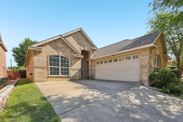 8208 Lonesome Spur Trl, Mckinney, TX 75070 - view of front facade with driveway, a garage, stone siding, and brick siding