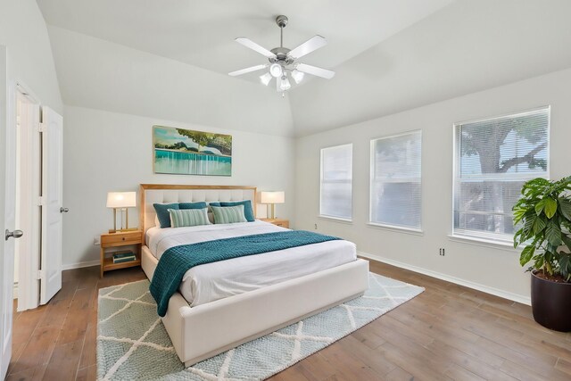 8208 Lonesome Spur Trl, Mckinney, TX 75070 - bedroom with lofted ceiling, wood finished floors, multiple windows, and baseboards