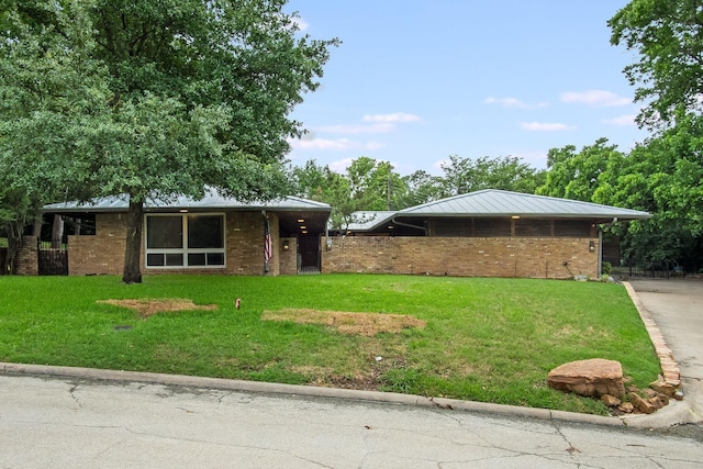 921 NW 9th St, Grand Prairie, TX 75050 - view of front of home with a front lawn and brick siding