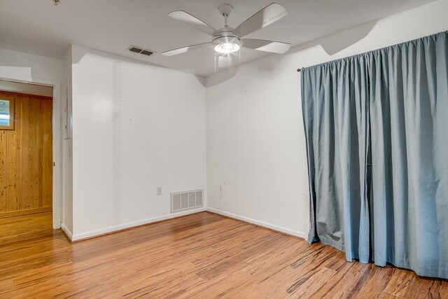921 NW 9th St, Grand Prairie, TX 75050 - unfurnished room with wood finished floors, a ceiling fan, and baseboards