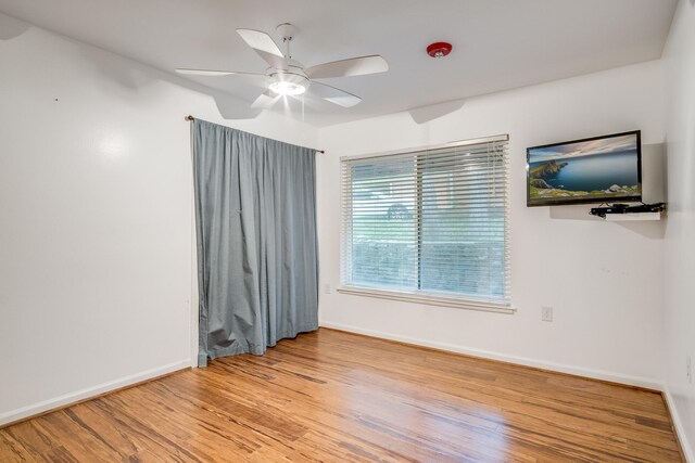 921 NW 9th St, Grand Prairie, TX 75050 - spare room featuring wood finished floors, ceiling fan, and baseboards