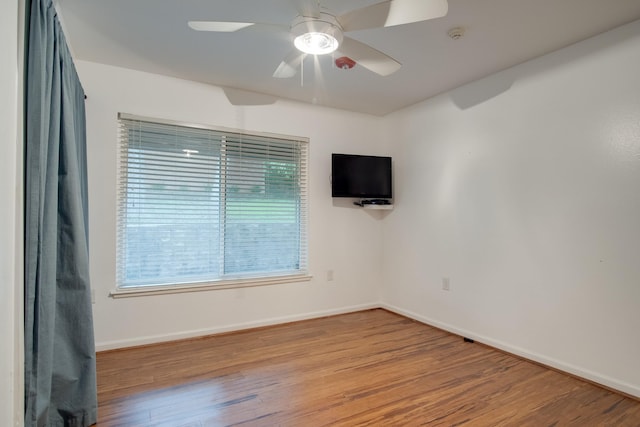 921 NW 9th St, Grand Prairie, TX 75050 - empty room with wood finished floors, plenty of natural light, and baseboards