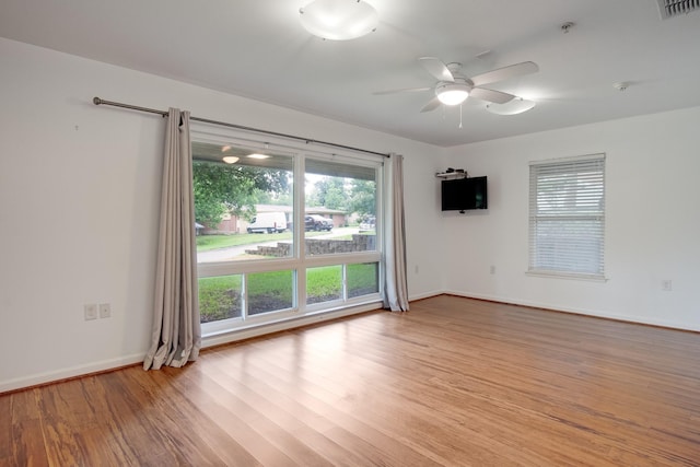 921 NW 9th St, Grand Prairie, TX 75050 - unfurnished room featuring light wood finished floors, a ceiling fan, a pendent fire sprinkler, and baseboards