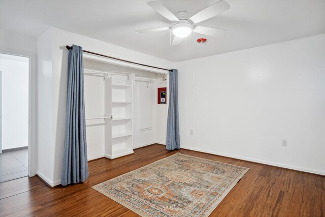 921 NW 9th St, Grand Prairie, TX 75050 - unfurnished bedroom with wood finished floors, baseboards, and ceiling fan