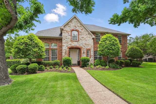 444 Avalon Ln, Coppell, TX 75019 - view of front facade featuring a front yard, brick siding, stone siding, and a shingled roof